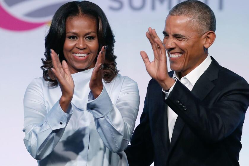 (FILES) In this file photo taken on October 31, 2017, former US President Barack Obama and First Lady Michelle Obama arrive at the Obama Foundation Summit in Chicago, Illinois. Barack and Michelle Obama have entered into a multi-year agreement to produce films and series with Netflix, the world's leading internet entertainment service announced on May 21, 2018. The former first couple have launched Higher Ground Productions to produce a variety of content for the video streamer, possibly including scripted series, documentaries and features. / AFP PHOTO / Jim YoungJIM YOUNG/AFP/Getty Images ** OUTS - ELSENT, FPG, CM - OUTS * NM, PH, VA if sourced by CT, LA or MoD **