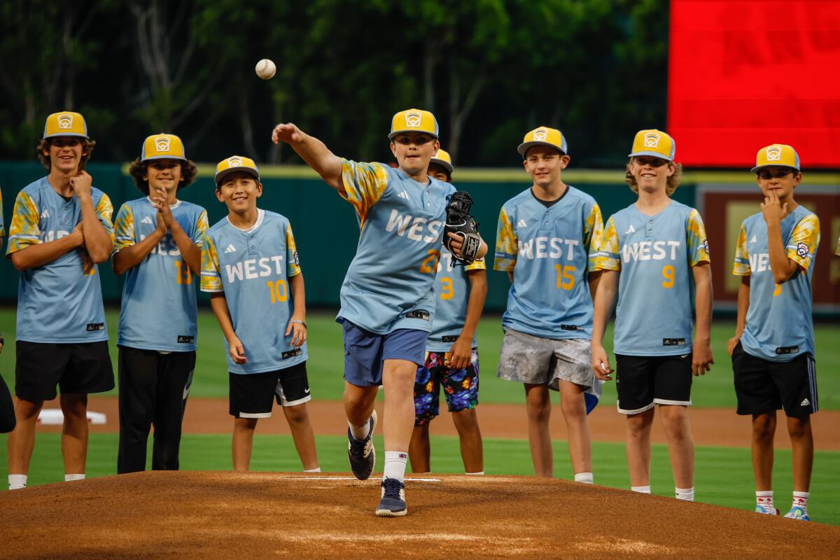 El Segundo Little League Baseball player Crew O'Connor throws a celebratory first pitch at Angel Stadium.