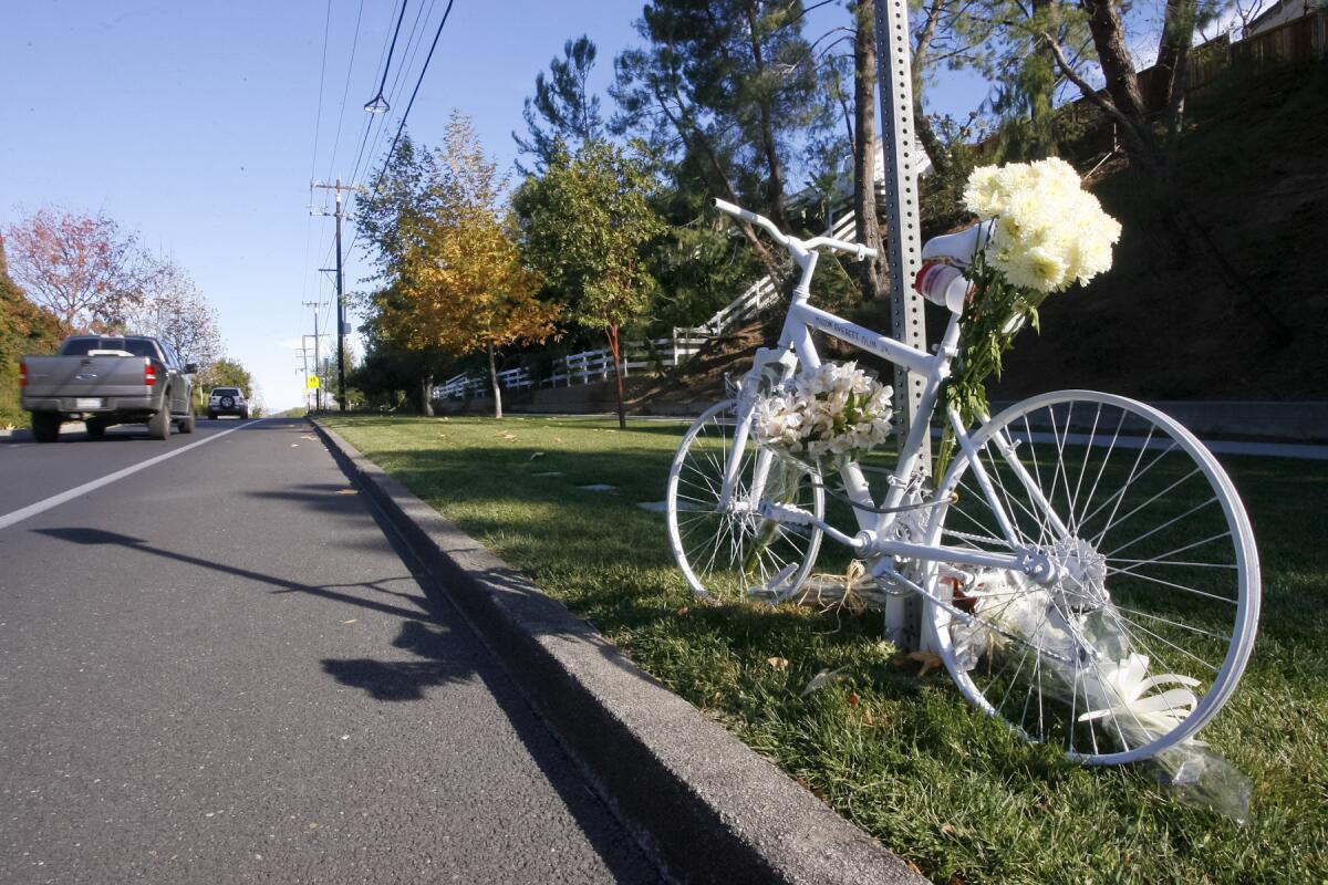 A memorial at the site on Mulholland Highway in Calabasas, where a Los Angeles County sheriff's deputy struck and killed Milton Olin Jr. as he was cycling on Dec. 8, 2013.