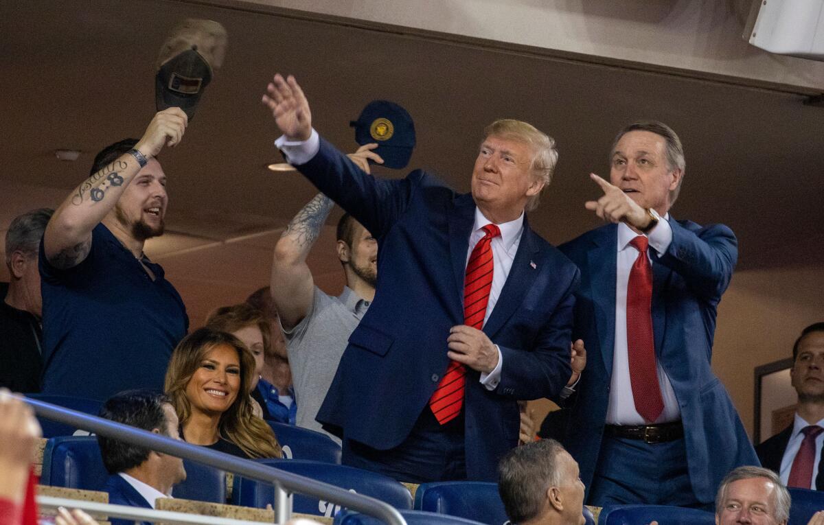 President Donald Trump, with wife Melania (left) and Sen. David Perdue (right) at Game 5 of the 2019 World Series