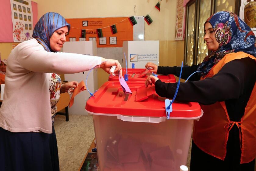 A Libyan woman casts her ballot at a polling station in Tripoli.