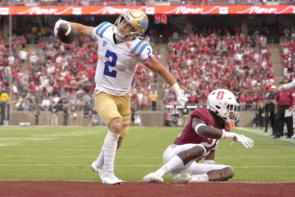 UCLA receiver Kyle Philips celebrates after catching a pass for a touchdown in front of Stanford safety Kendall Williamson.