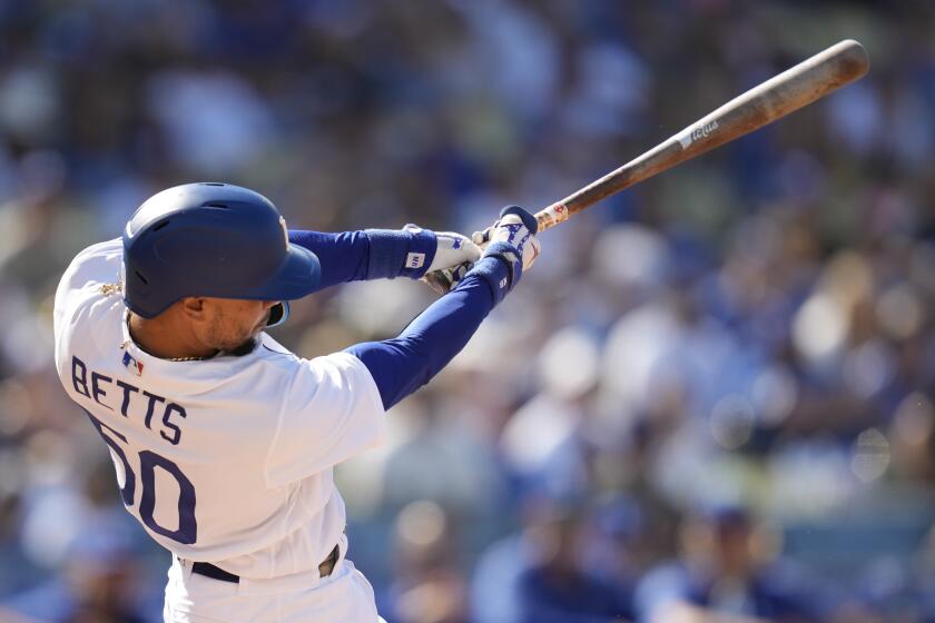 Los Angeles Dodgers' Mookie Betts (50) hits a home run during the first inning of a baseball game against the Houston Astros in Los Angeles, Sunday, June 25, 2023. (AP Photo/Ashley Landis)