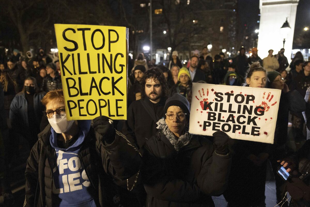 FILE - Demonstrators hold signs during a protest at Washington Square Park in New York on Jan. 28, 2023, in response to the death of Tyre Nichols, who died after being beaten by Memphis police during a traffic stop. The beating and death of Nichols by members of a plainclothes anti-crime task force has renewed scrutiny on the squads often involved in a disproportionate number of use of force incidents and civilian complaints. (AP Photo/Yuki Iwamura, File)