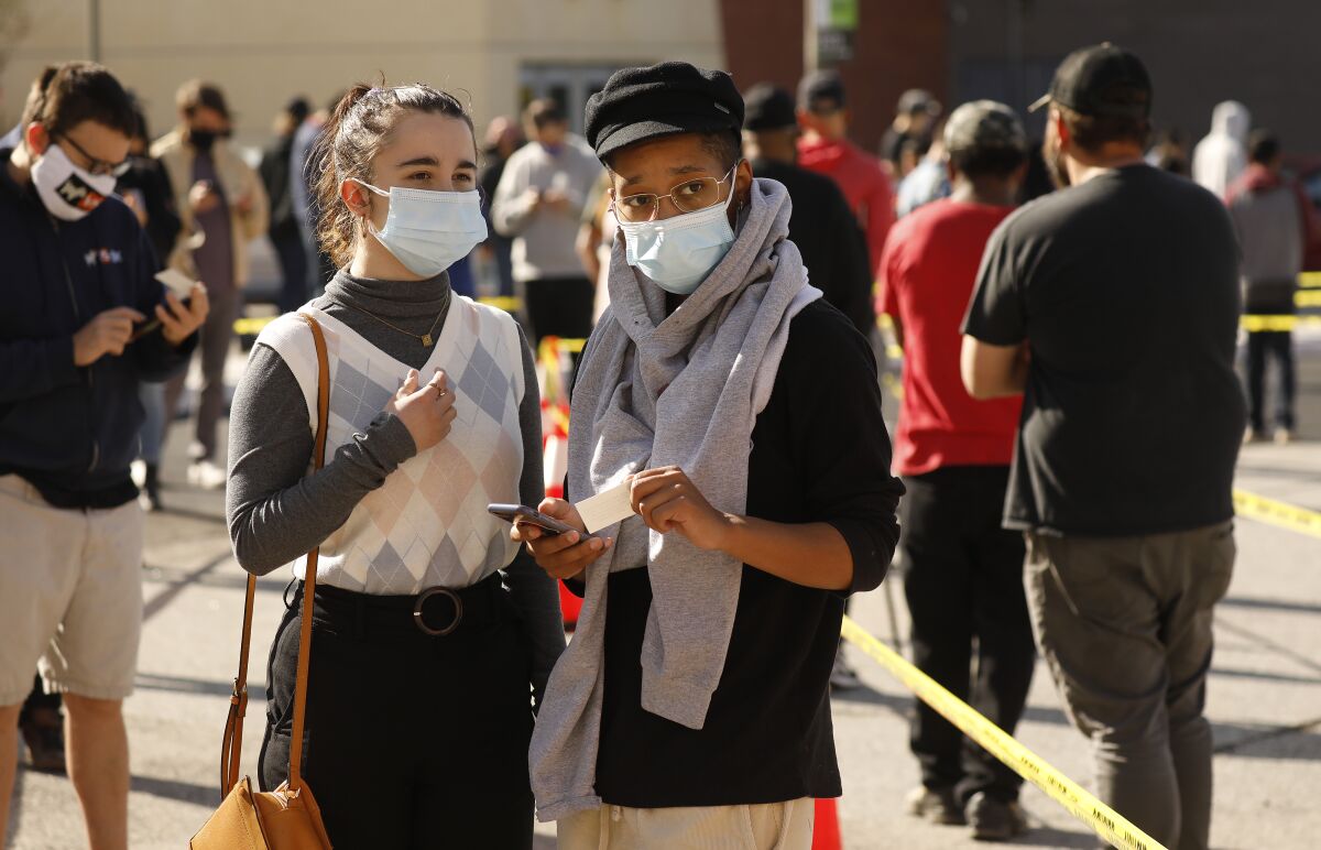 People wait in line for vaccinations at Cal State L.A. on April 9. 