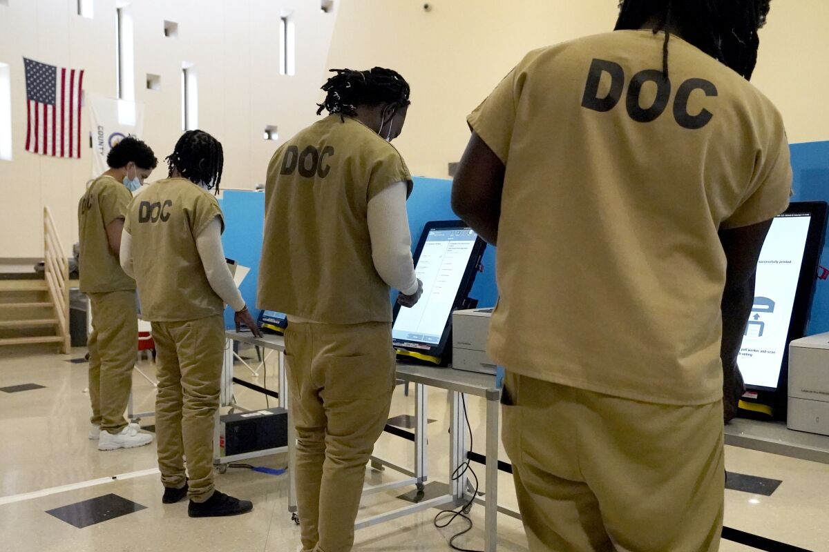 Inmates at the Cook County, Ill., jail vote in a local election at the jail's Division 11 Chapel on Saturday, Feb. 18, 2023, in Chicago. (AP Photo/Charles Rex Arbogast)