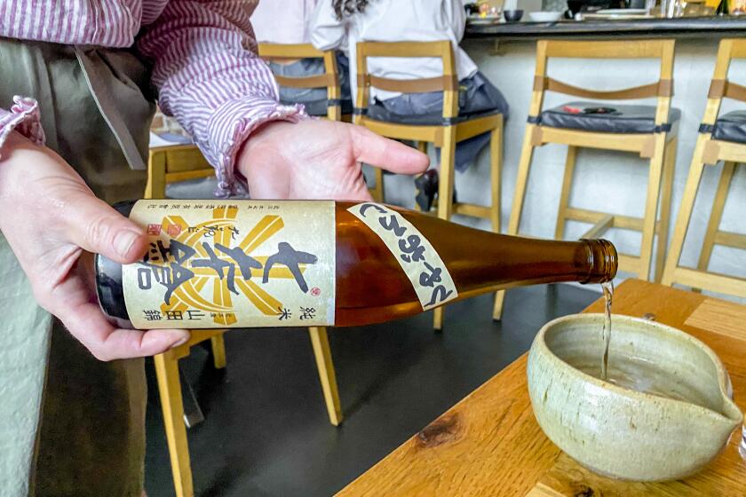 Courtney Kaplan pouring sake at Tsubaki in Echo Park.