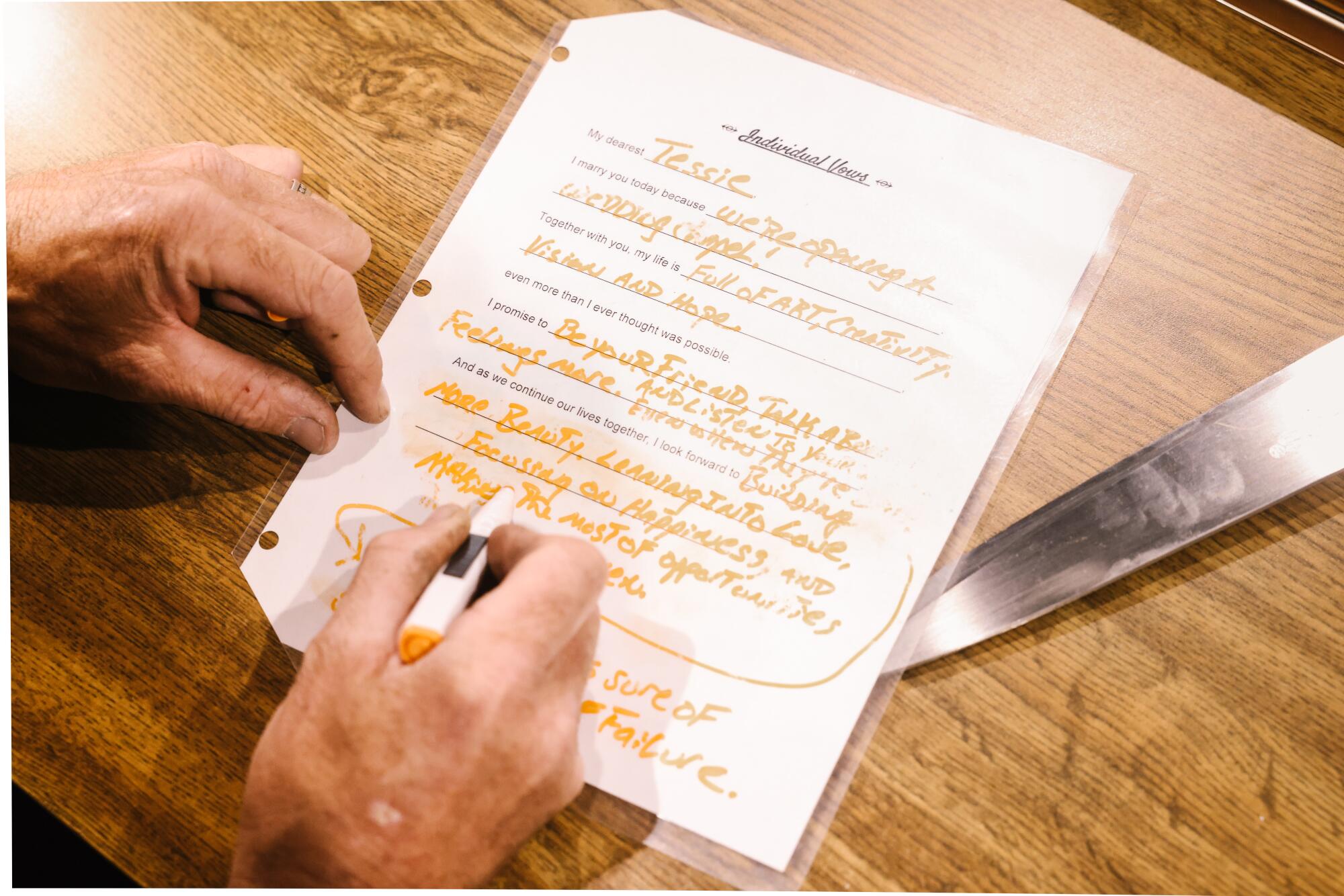 Dan Gambelin writes his wedding vows on a form.