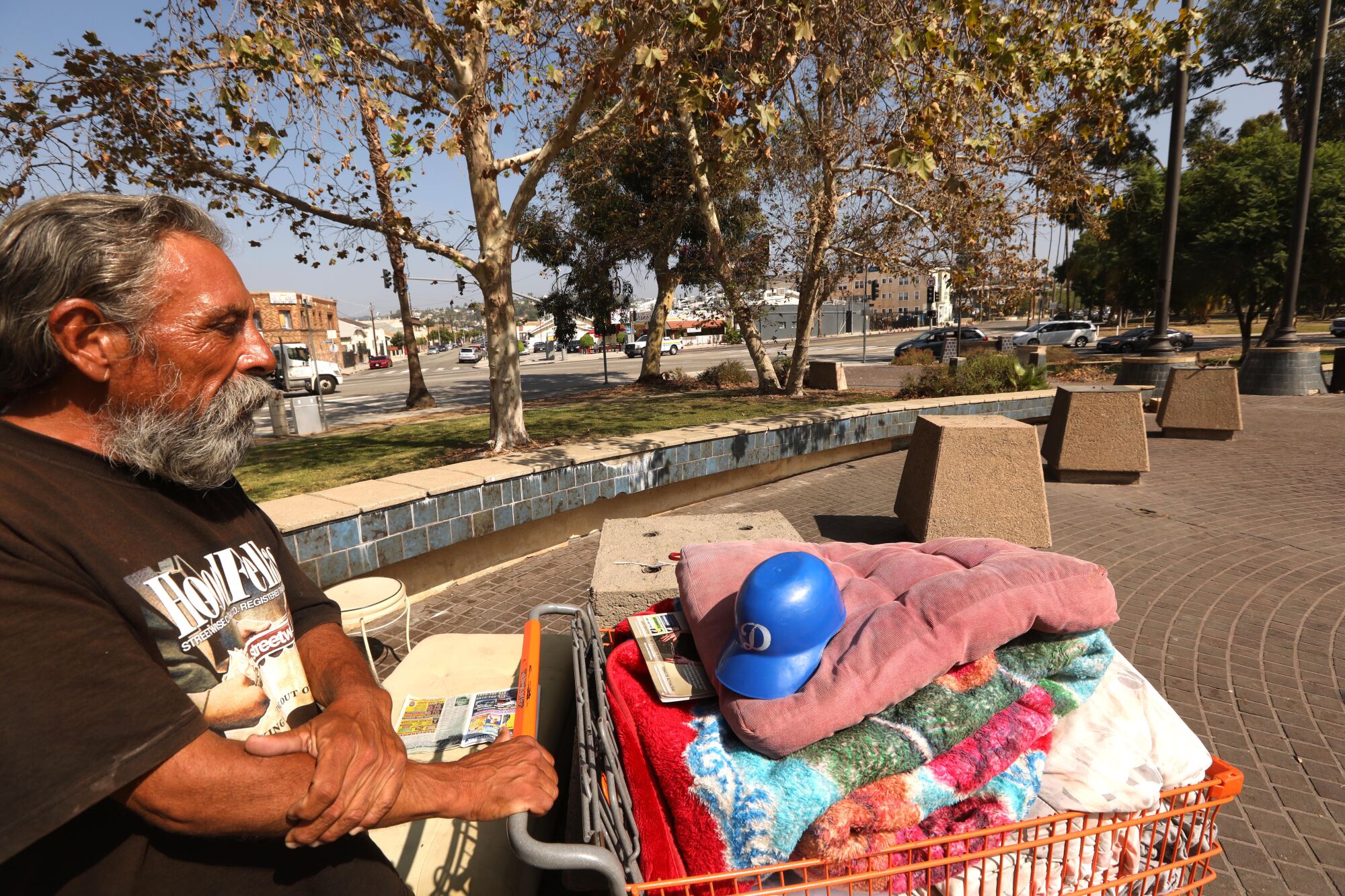 Former truck driver Paul Carrera stands next to his belongings in Lincoln Heights. 