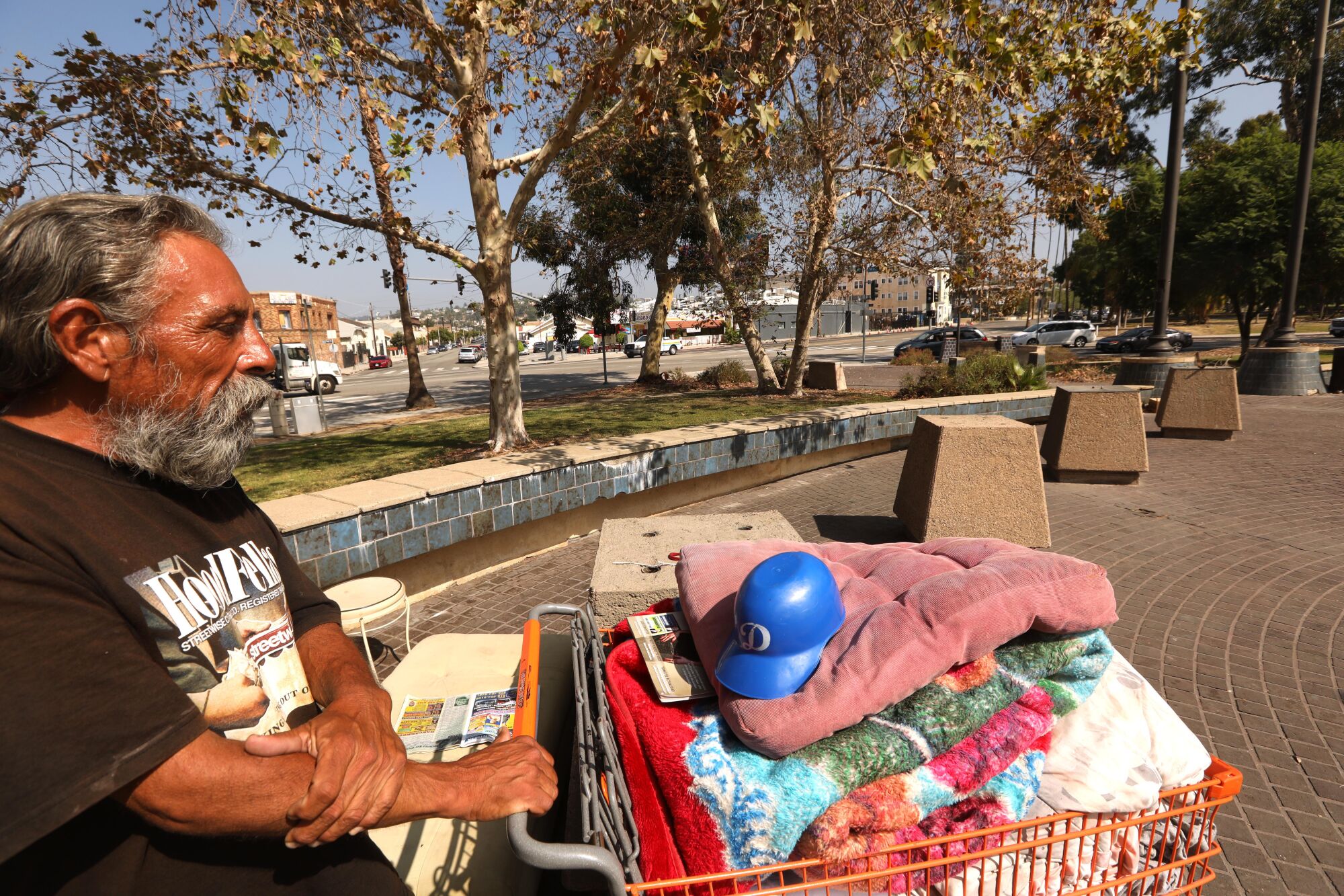 Former truck driver Paul Carrera stands next to his belongings in Lincoln Heights.