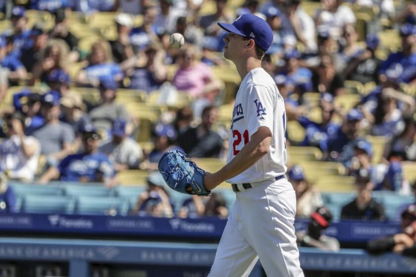 LOS ANGELES, CA, SUNDAY, MARCH 31, 2019 - Dodgers pitcher Walker Buehler tosses the ball in apparent frustration during the fourth inning where he allowed five runs to the Diamondbacks and was pulled from the game by manager Dave Roberts at Dodger Stadium. (Robert Gauthier/Los Angeles Times)