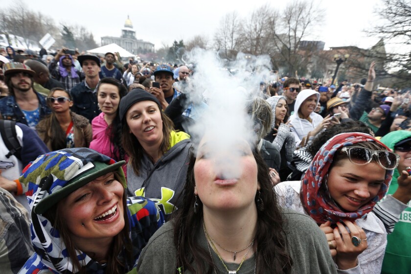 Partygoers dance and smoke pot during the annual 4/20 marijuana festival in Denver on April 19, 2014. Ten sheriffs from three different states sued Colorado on March 5, 2015 for decriminalizing marijuana — joining a handful of recent legal challenges urging courts to strike down the state's legalization of recreational pot.