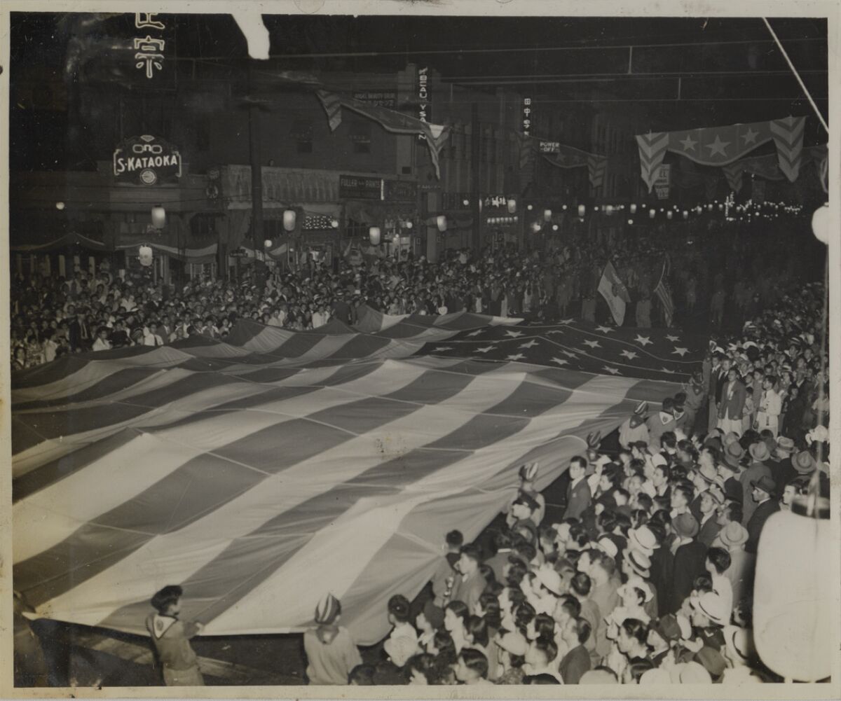 Boy Scouts hold up an American flag during a parade in Los Angeles in 1938.