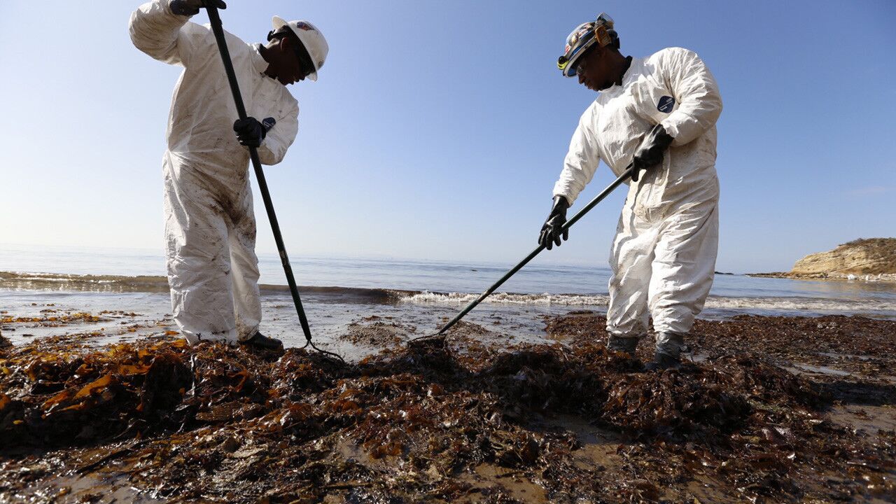 Patriot Cleanup workers bag oiled sand and kelp at Refugio State Beach on Wednesday morning.