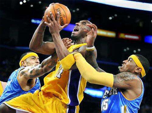 Lakers guard Kobe Bryant draws a foul from Denver power forward Kenyon Martin after driving past Carmelo Anthony in the first half on Thursday night.