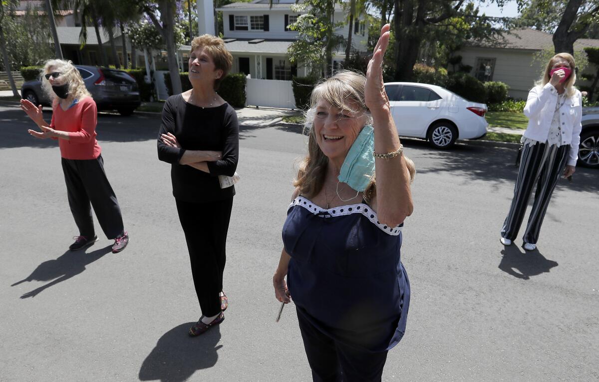 Neighbors sing "Happy Birthday" to Joan Bayley.