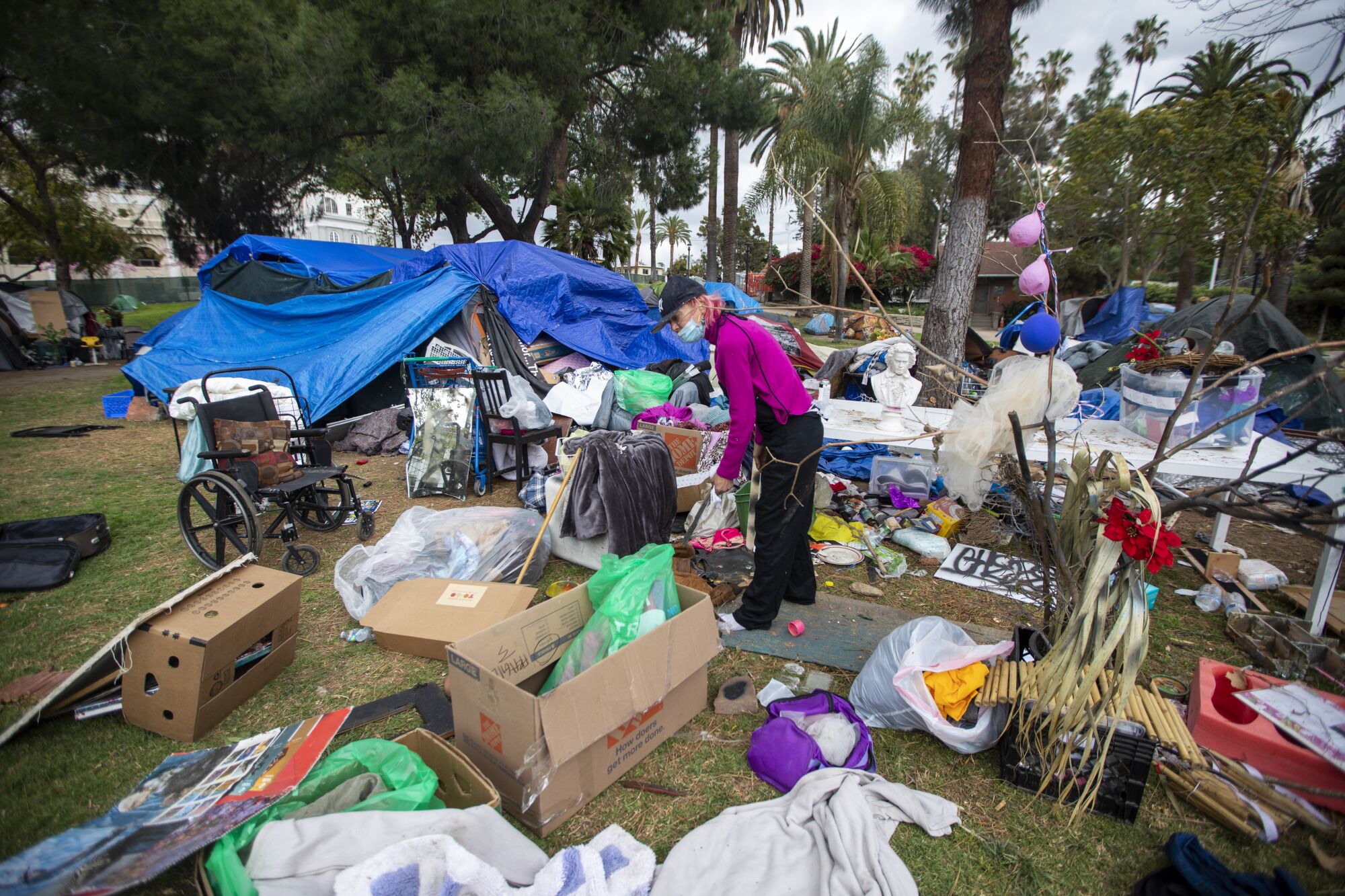March 2021 photo of Valerie Zeller trying to organize her belongings from a homeless encampment in Echo Park Lake.