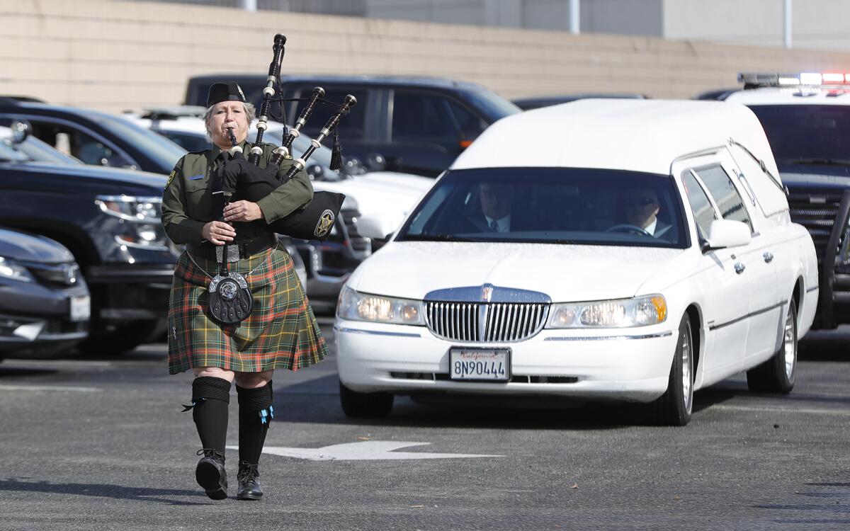 An Orange County Sheriff bagpiper begins the procession in honor of fallen Officer Nicholas Vella.