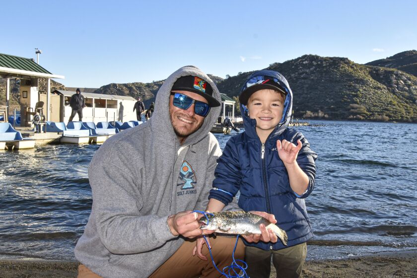 John Zaragoza and son, Aiden, show off Aiden's first catch of the day.