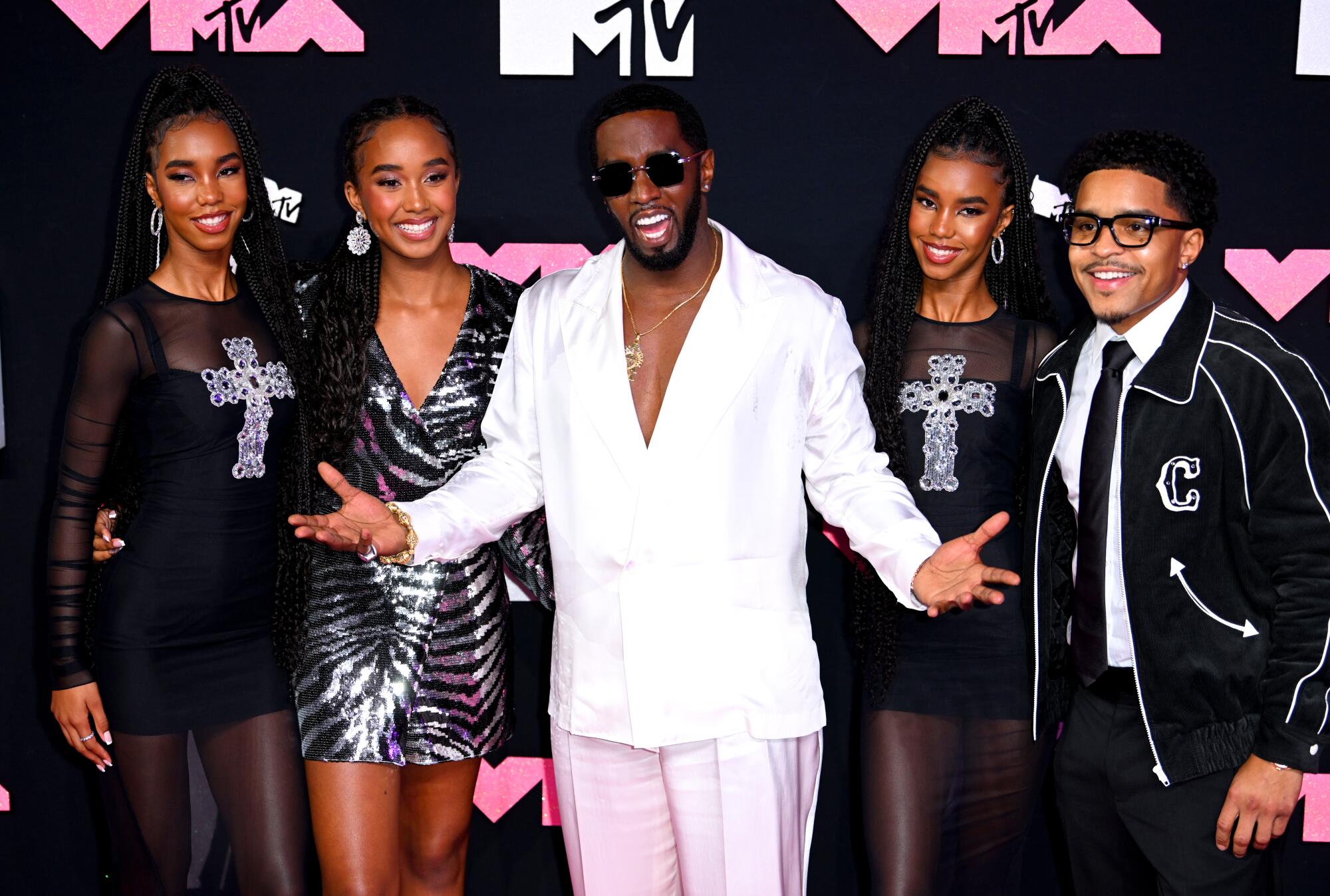 Diddy, flanked by four of his children, at the 2023 MTV Video Music Awards.
