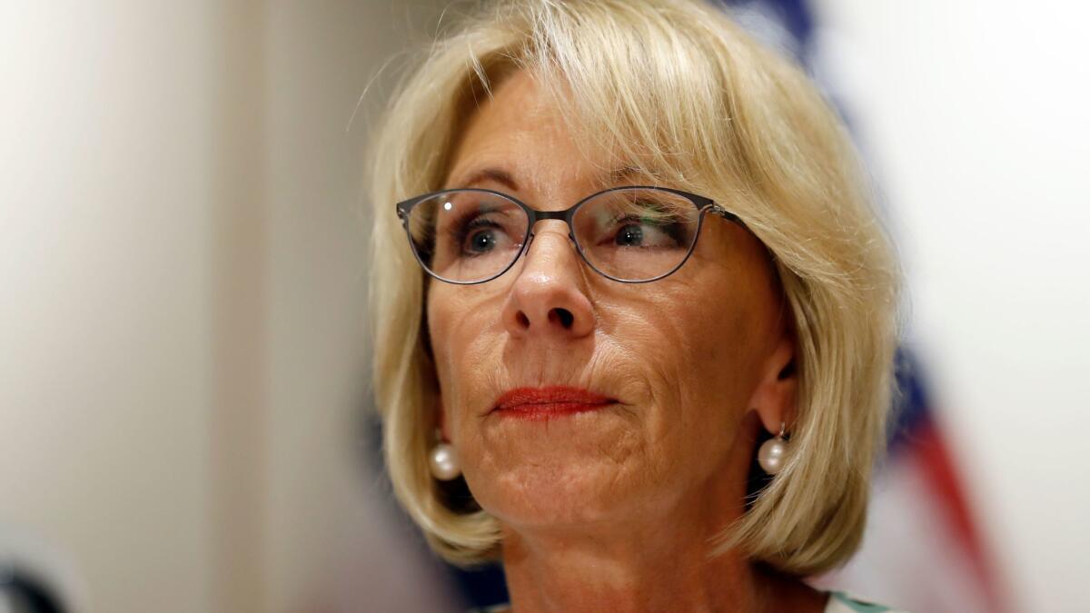 Education Secretary Betsy DeVos pauses while speaking with the media after a series of "listening sessions" on campus sexual violence.