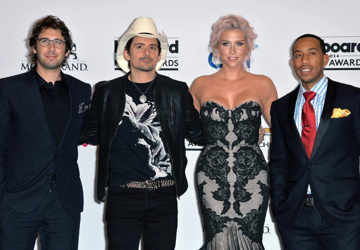 Singers Josh Groban, Brad Paisley and Kesha and host Chris 'Ludacris' Bridges pose in the press room during the 2014 Billboard Music Awards at the MGM Grand Garden Arena on May 18, 2014 in Las Vegas, Nevada.