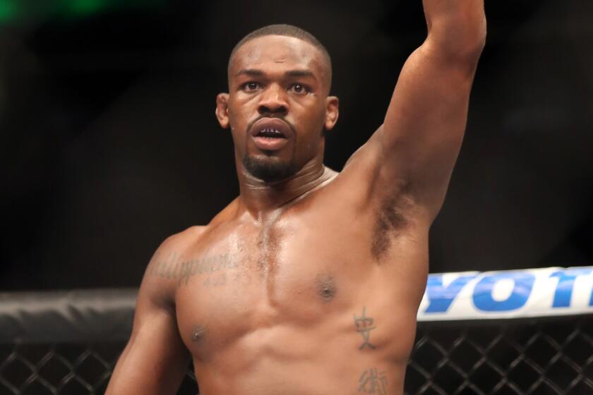 Jon Jones celebrates after beating Chael Sonnen in a UFC heavyweight title bout on April 27, 2013.