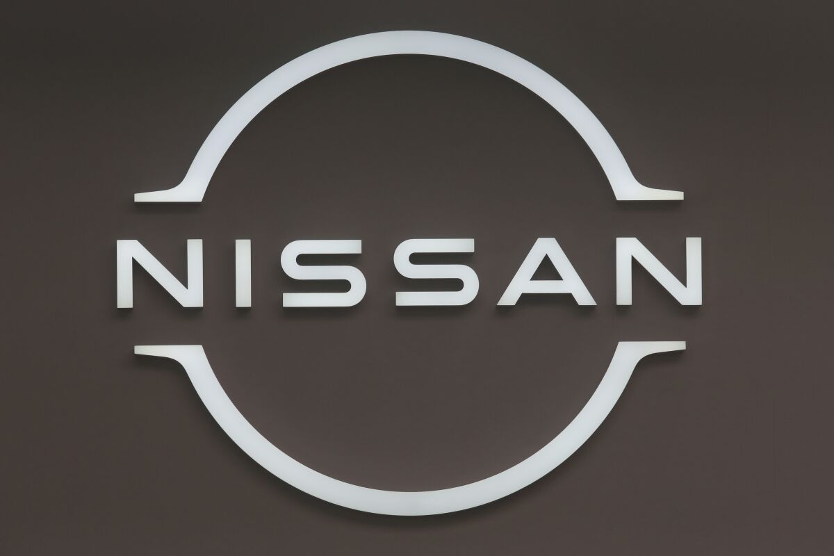 FILE - Nissan logo is seen in a show room in Tokyo, on Nov. 29, 2021. Nissan is working with NASA on a new type of battery for electric vehicles that promises to charge quicker and be lighter yet safe, the Japanese automaker said Friday, April 8, 2022. (AP Photo/Koji Sasahara, File)