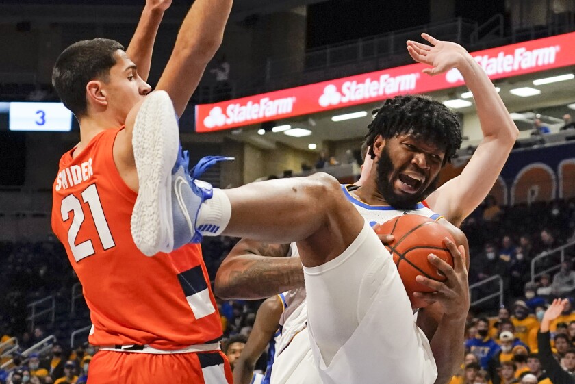 Pittsburgh's John Hugley, right, grabs a rebound between Syracuse's Cole Swider (21) and Jimmy Boeheim during the first half of an NCAA college basketball game, Tuesday, Jan. 25, 2022, in Pittsburgh. (AP Photo/Keith Srakocic)