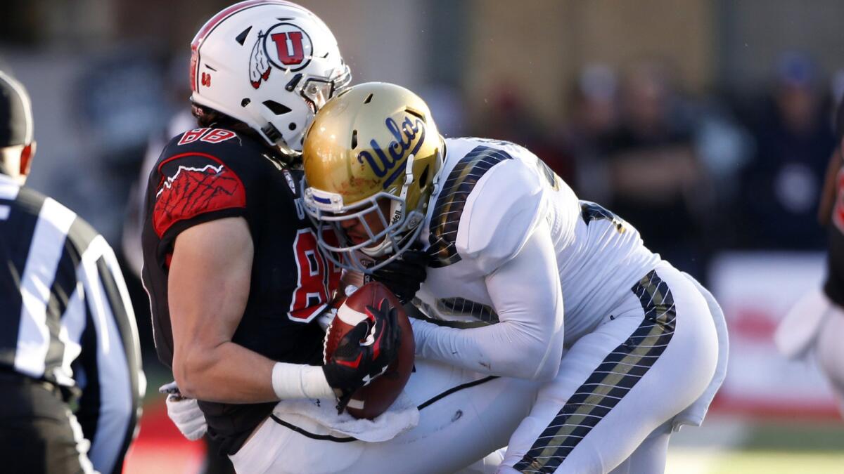 Utah receiver Harrison Handley is brought down by UCLA defensive back Nate Meadors in the second half.