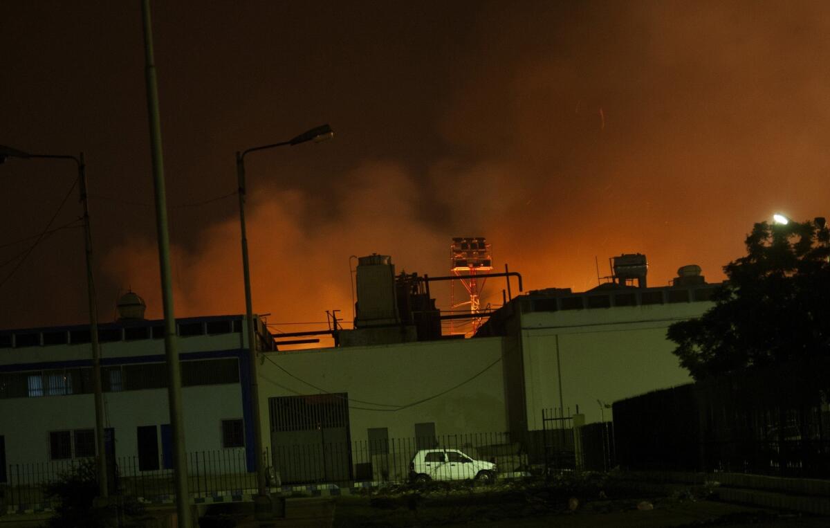 Fire illuminates the sky above an airport terminal late Sunday in Karachi, Pakistan.