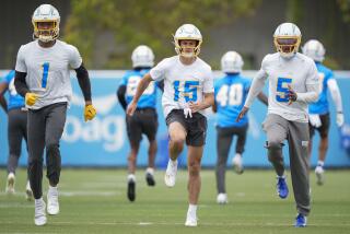 Chargers receivers Quentin Johnston (1), Ladd McConkey (15) and Joshua Palmer (5) warm up before practice.