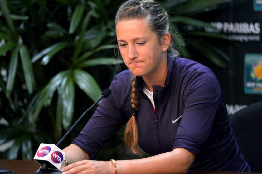 Victoria Azarenka pauses during a news conference Thursday to announce that she has withdrawn from the BNP Paribas Open tennis tournament because of an ankle injury.