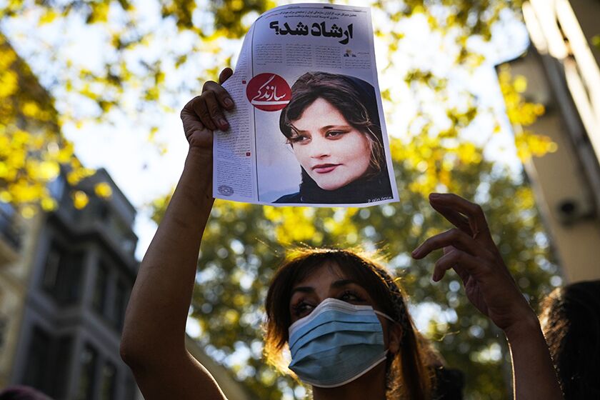A photo of Iranian Mahsa Amini is displayed in Istanbul during a protest against her death.