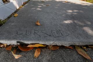 Venice, CA, Tuesday, August 13, 2024 - Graffiti etched into a damaged sidewalk slab on Nowita Pl. may be a reflection of the state of this neighborhood's walkways. Dennis Hathaway, who lives in Venice and blogs about aging, thinks bad sidewalks are a senior hazard. We go for a walk in his neighborhood with him and his wife, Laura Silagi. (Robert Gauthier/Los Angeles Times)