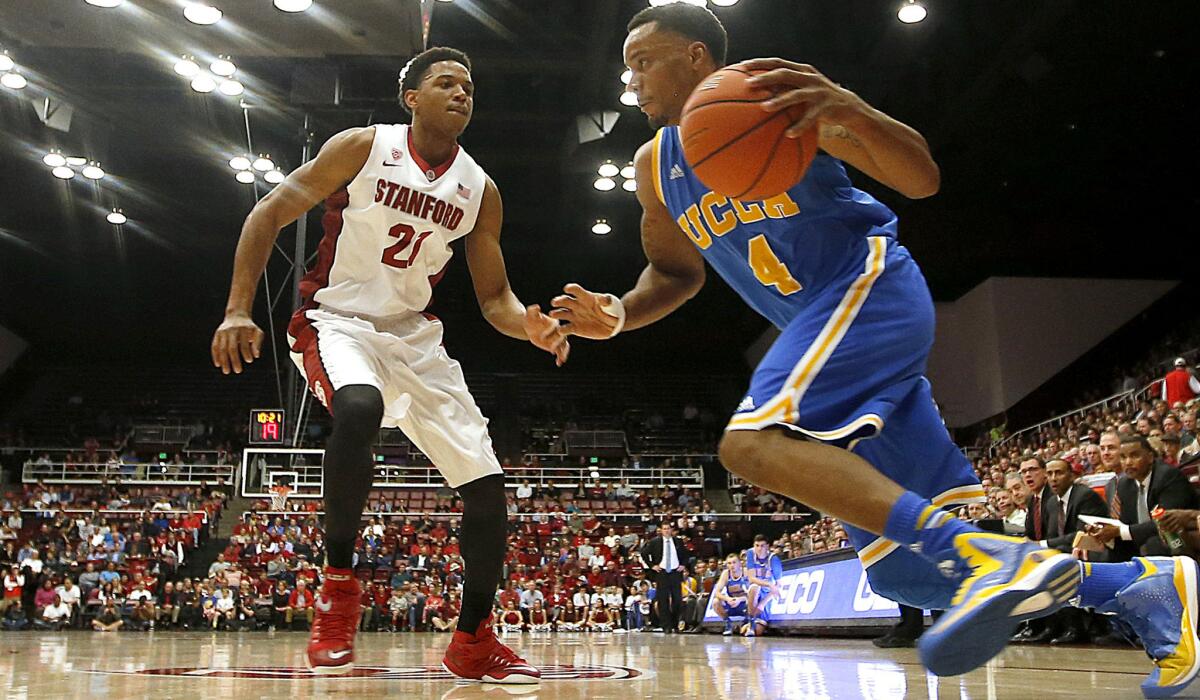 UCLA guard Norman Powell (4) drives past Stanford forward Anthony Brown (21) during the first half of an NCAA college basketball game Thursday, Feb. 5, 2015, in Stanford, Calif. (AP Photo/Tony Avelar)