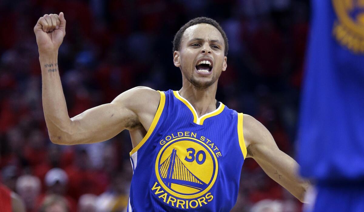 Warriors guard Stephen Curry, who finished with 40 points, celebrates the Warriors' 123-119 overtime victory over the Pelicans on Thursday night in New Orleans.