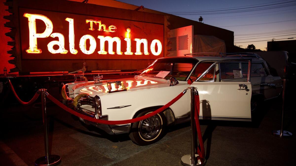 The 1964 Pontiac Bonneville station wagon owned by Nudie Cohn, on loan to the Valley Relics Museum, sits in front of the Palomino neon sign in 2018.