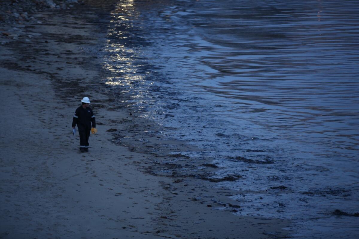 Authorities inspect the oily shoreline at Refugio State Beach.