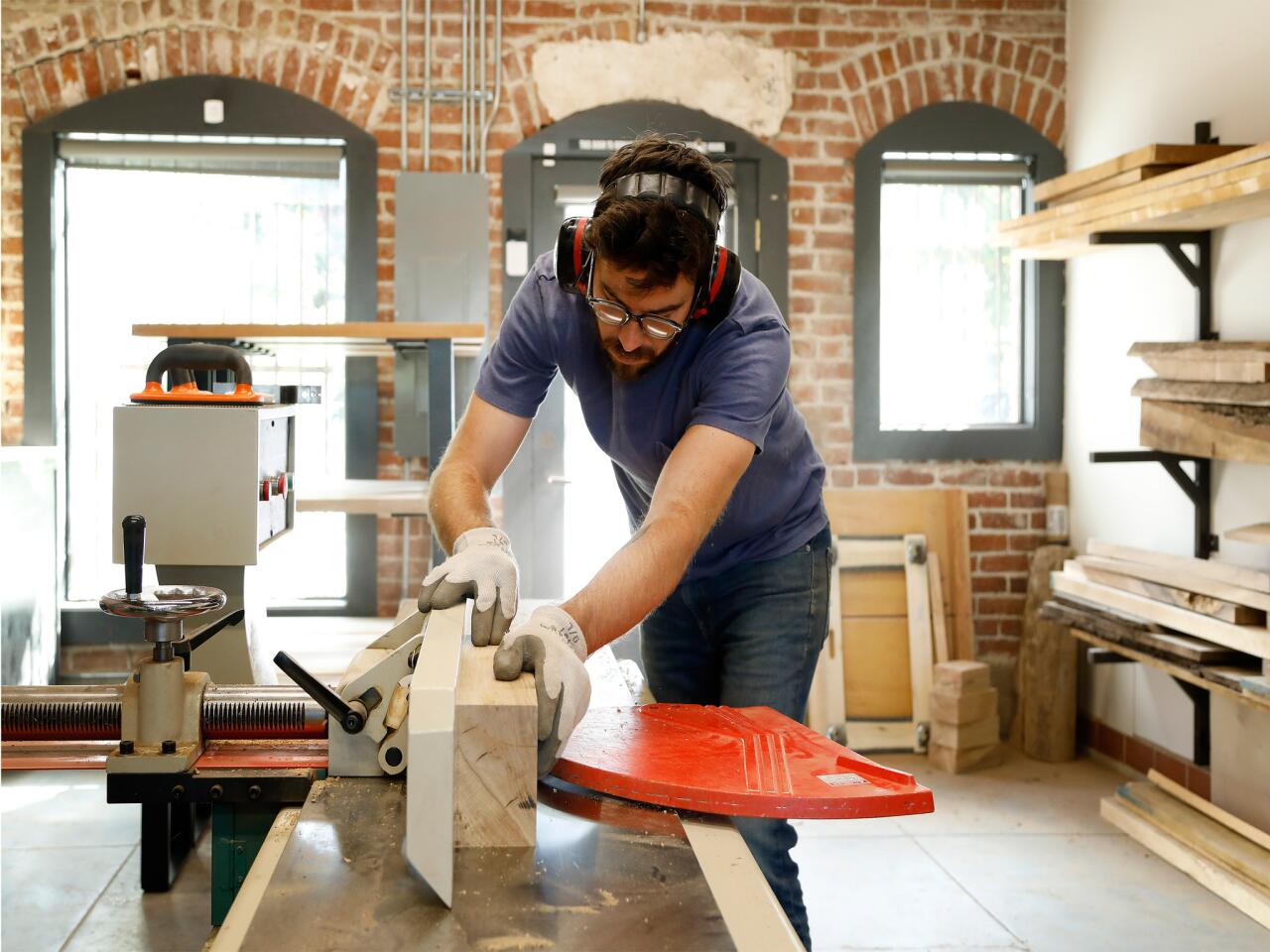Josh Jackson works on custom furnishings for a restaurant in his Pasadena woodworking studio.