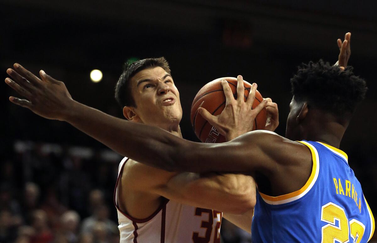 USC's Nikola Jovanovic looks for a shot while UCLA's Tony Parker defends.