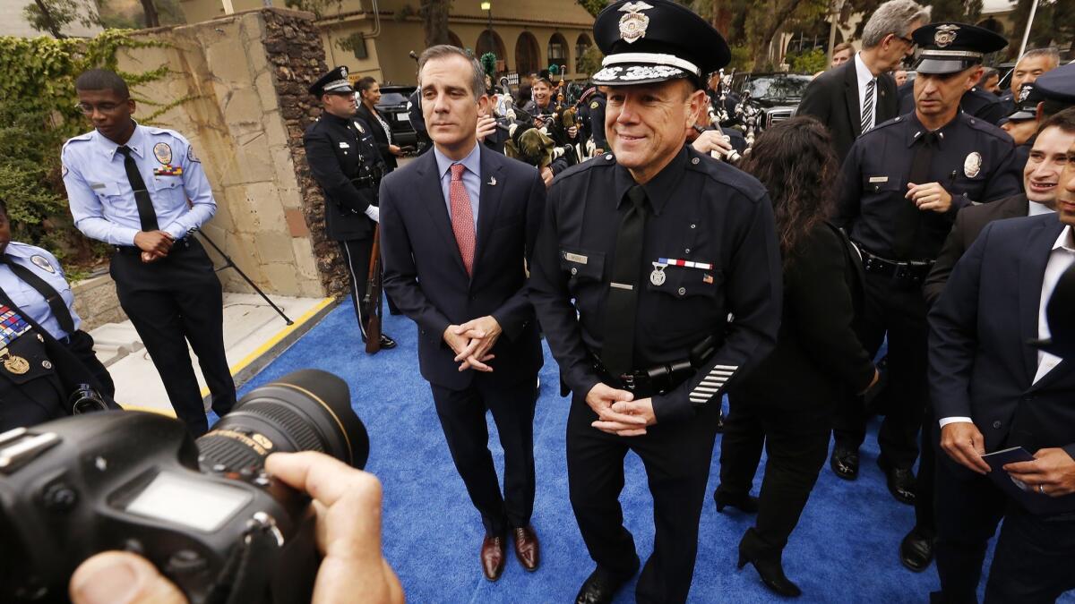 Los Angeles Mayor Eric Garcetti, left, and new LAPD Chief Michel Moore wait to walk into Moore's swearing-in ceremony.