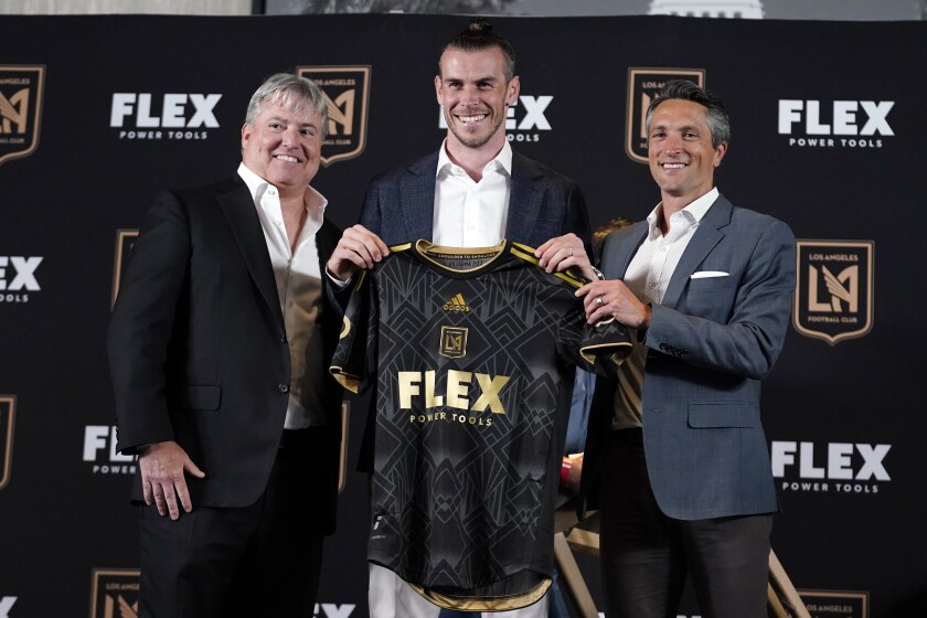 Gareth Bale (center) poses for photos with LAFC lead managing owner Larry Berg (left) and general manager John Torrington.