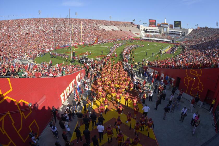 The USC Trojans take the field for a 2014 game against Notre Dame at the Coliseum.