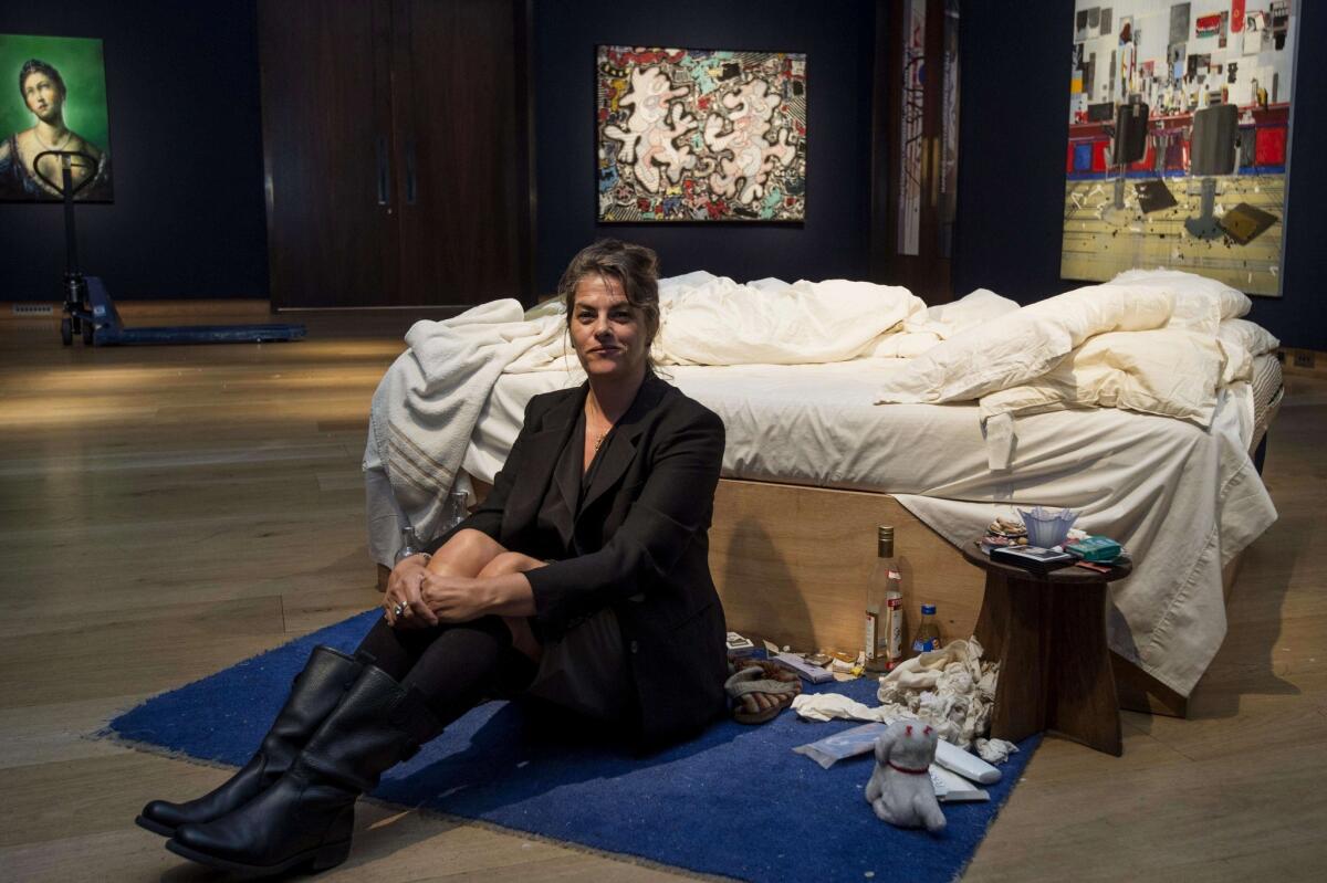 British artist Tracey Emin sits with her art installation, "My Bed," which sold at a London auction for more than $4 million.