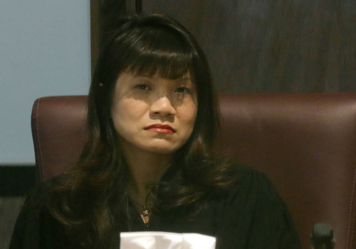 FILE - In this Tuesday, Oct. 22, 2013, file photo, Oklahoma County Judge Cindy Truong listens to testimony in court in Oklahoma City. On Monday, Oct. 4, 2021, Truong temporarily blocked two new anti-abortion laws from taking effect in the following month, including a measure similar to a Texas abortion ban that effectively prohibits abortions after about six weeks of pregnancy. (AP Photo/Sue Ogrocki, File)