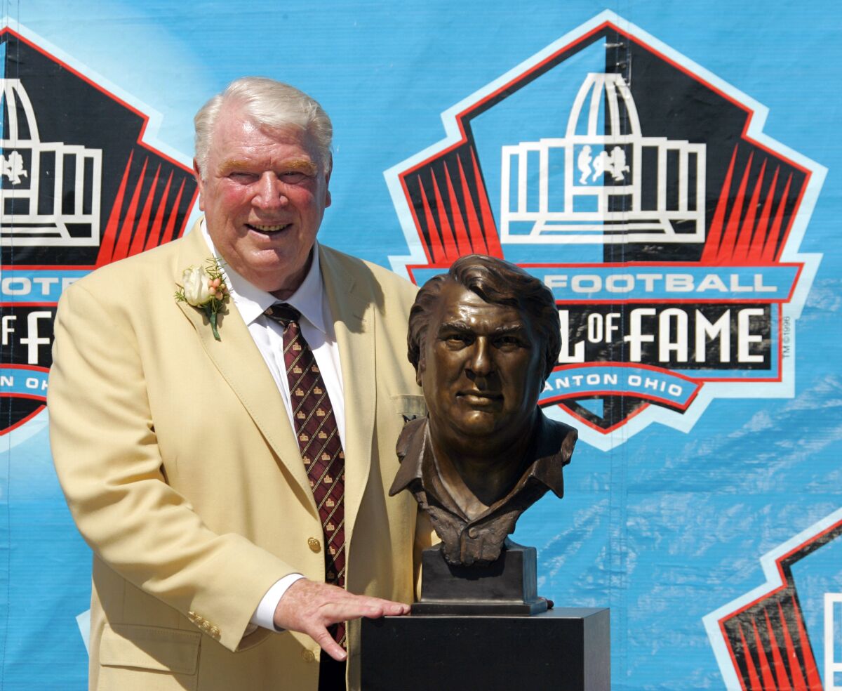 John Madden poses with his bust after enshrinement into the Pro Football Hall of Fame in 2006.