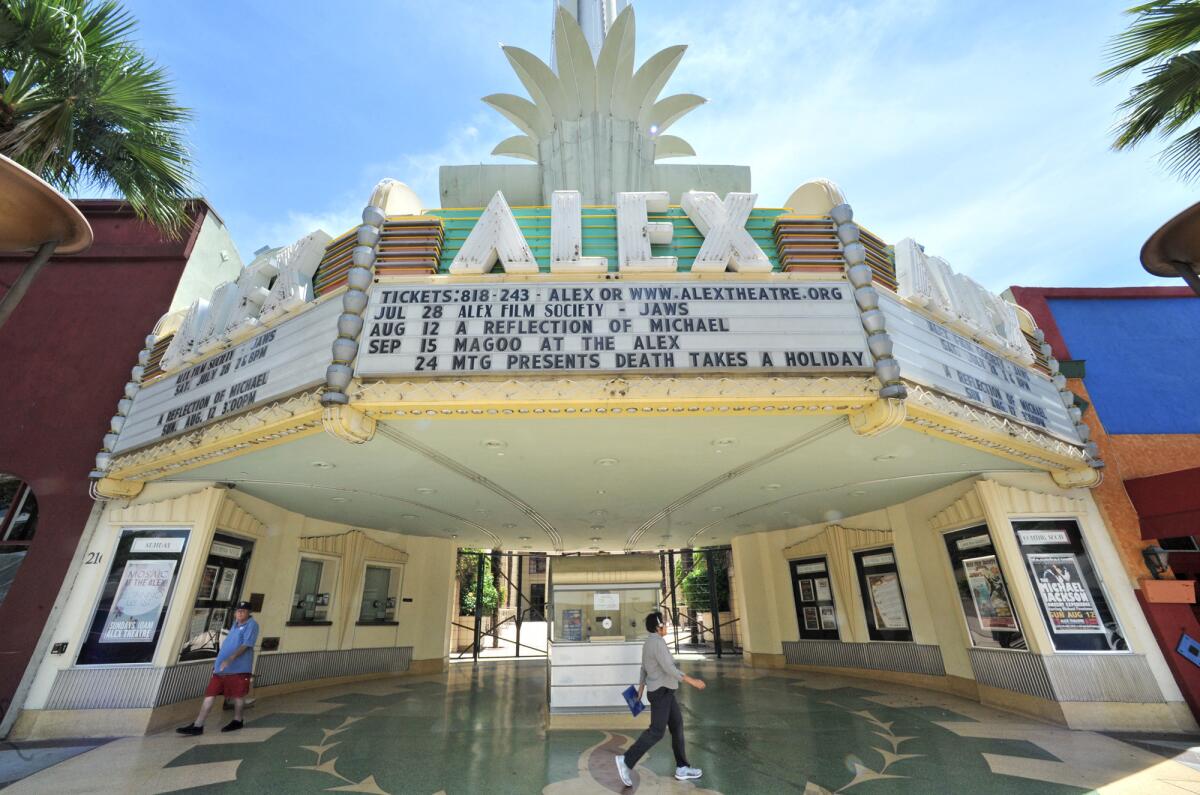 Pedestrians walk past the Alex Theatre on Tuesday, July 10, 2012.