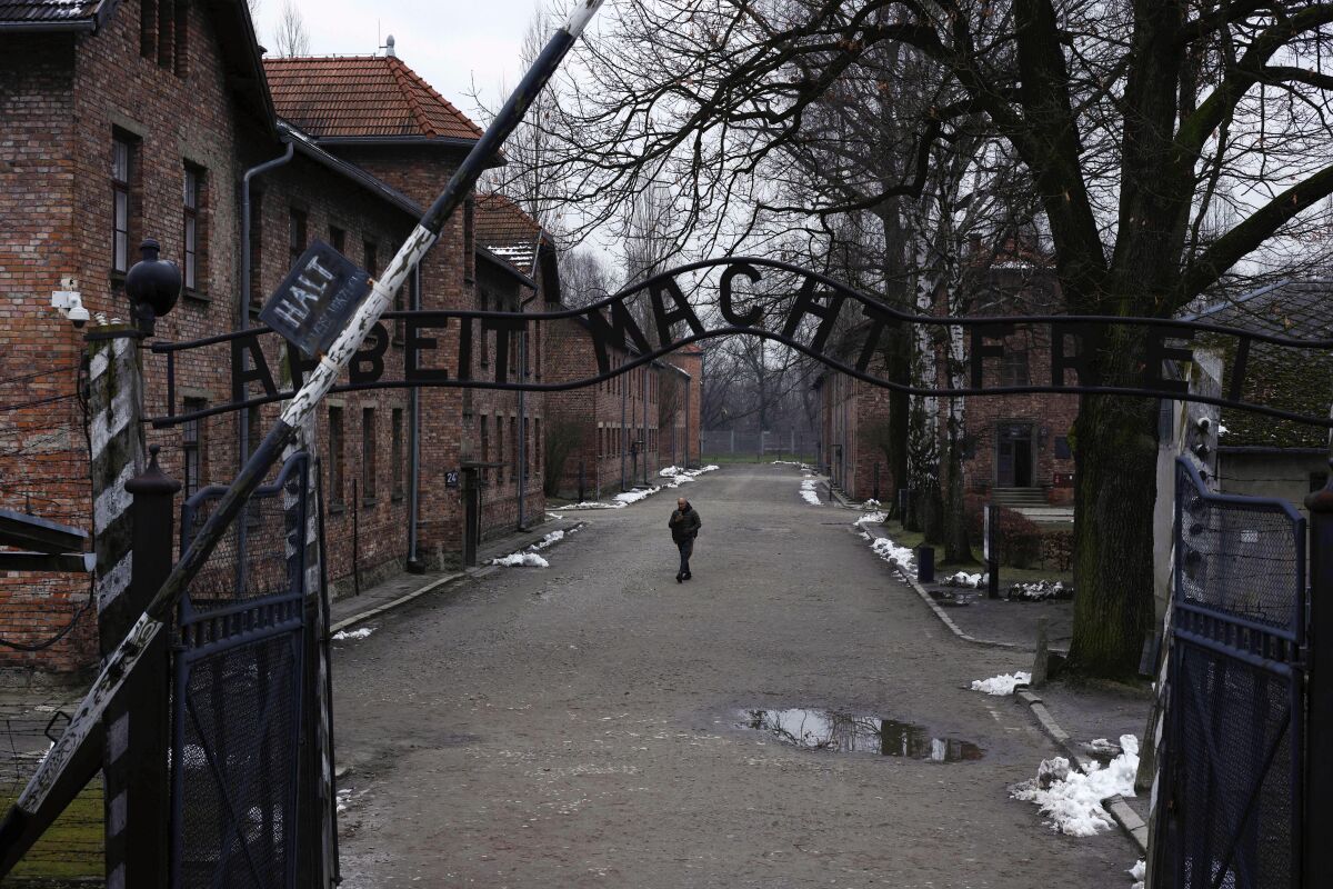 A man walks near the ''Arbeit Macht Frei" gate at the former Nazi extermination camp Auschwitz-Birkenau in Oswiecim, Poland.