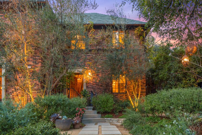 Built in 1927, the brick-clad abode boasts arched doorways, custom built-ins and period details across 3,240 square feet.